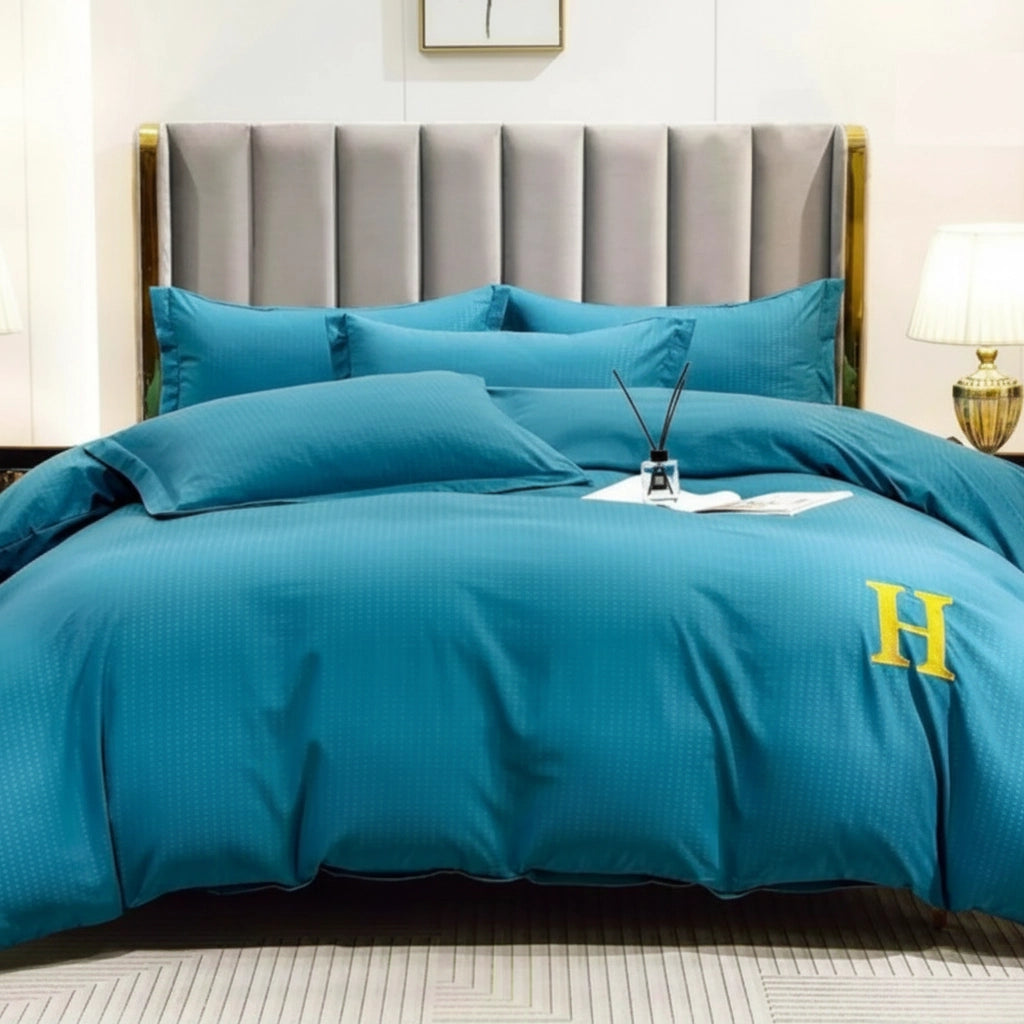 Deep teal bed sheet paired with quilt cover and pillow cover on modern bed