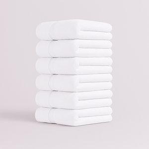 Stack of white towels set on a light gray background