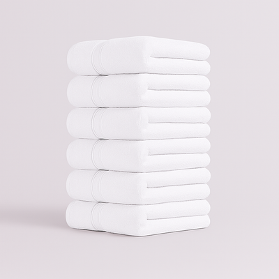 Stack of white towels set on a light gray background