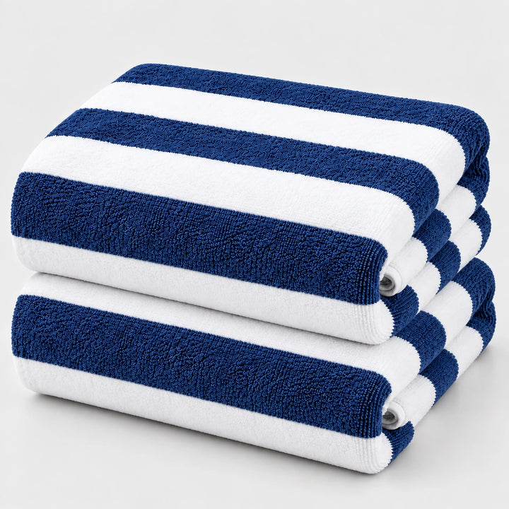 Two folded striped towels stacked on a light gray background. The towels have alternating navy blue and white horizontal stripes, with a visible terry cloth texture.