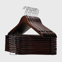 Set of dark wooden clothes hangers with curved shoulders and metal hooks